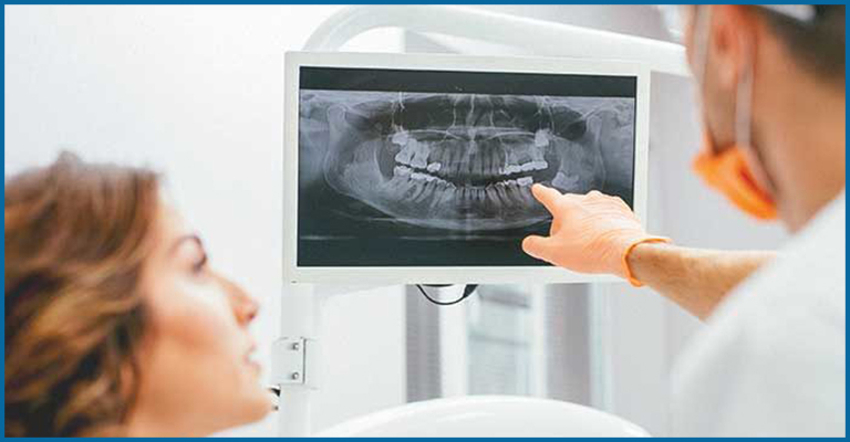 dentist showing x ray to patient