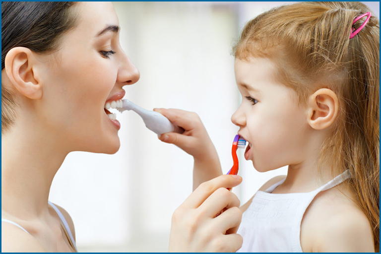 mom and child brushing teeth