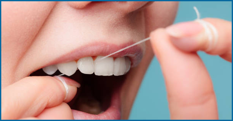 women flossing teeth
