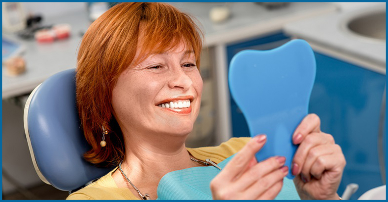 women smiling in front of mirror